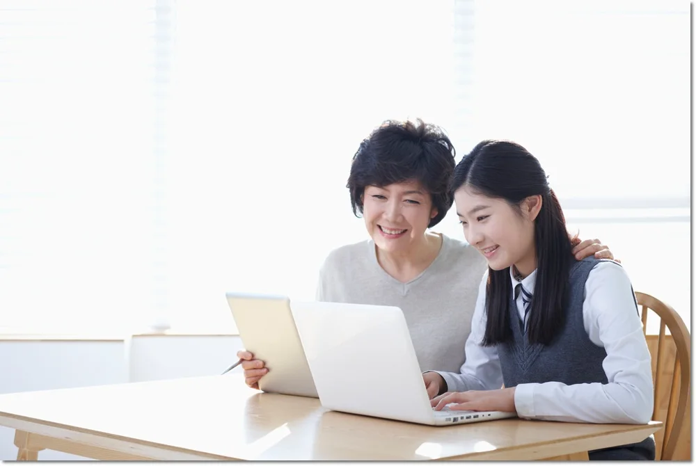 노트북을 함께 보는 학생들